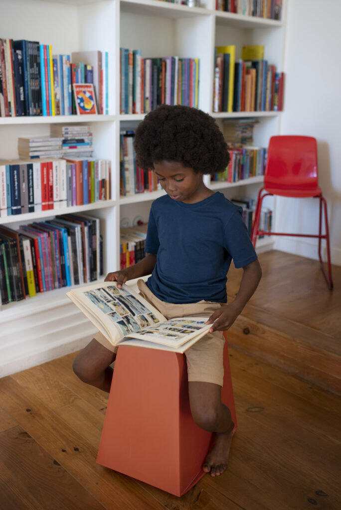 full shot boy reading comics home